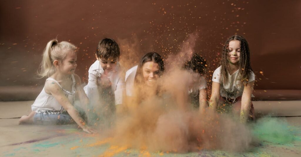 Cheerful children playing with vibrant colored powder, celebrating Holi indoors.