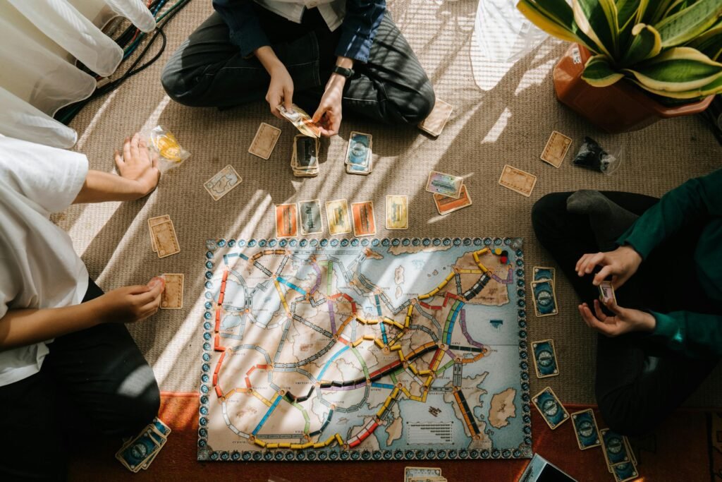 A group of children engaged in a board game on the carpet indoors, enjoying a leisure activity.