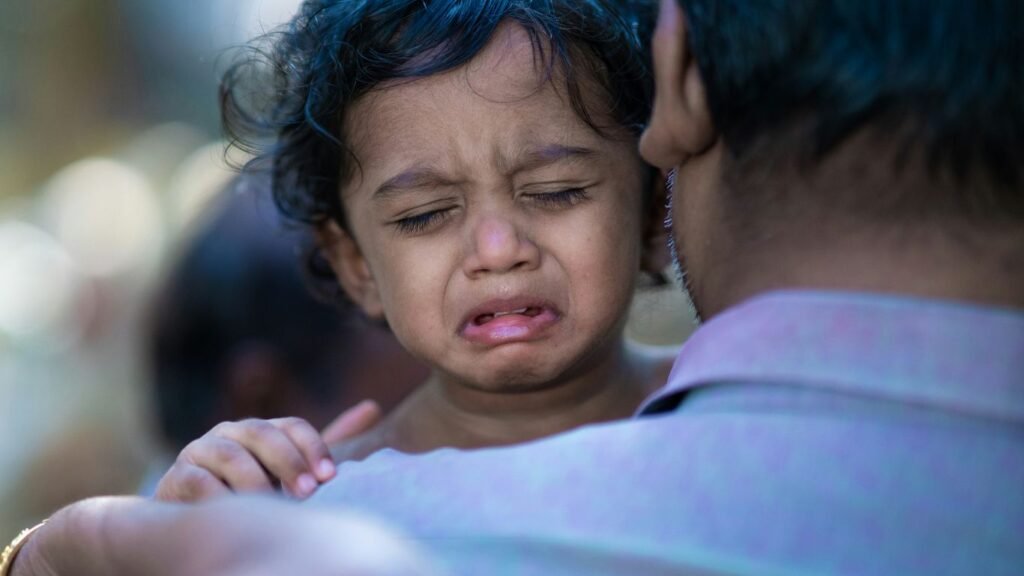 a woman holding a child with a surprised look on her face
