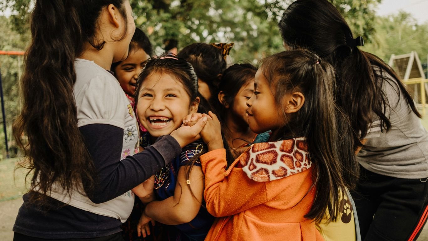 a group of young girls standing next to each other