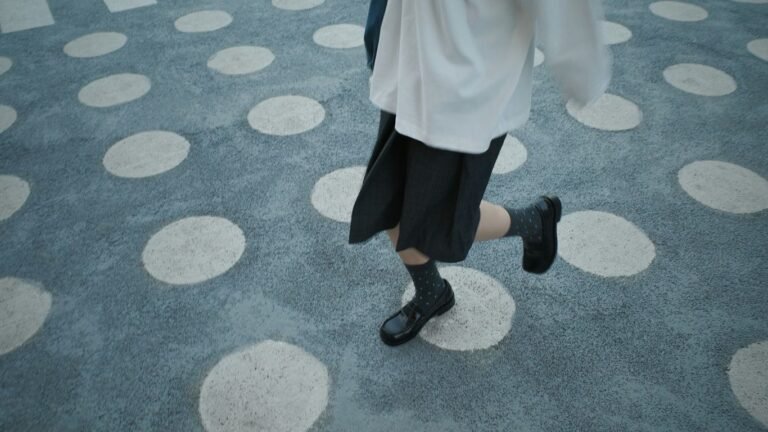 Person walking on a patterned ground with circles